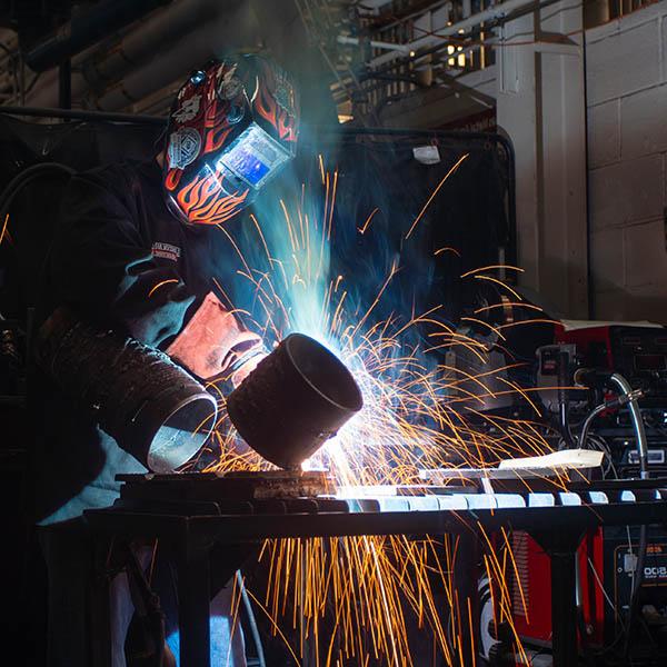 Student welding in lab